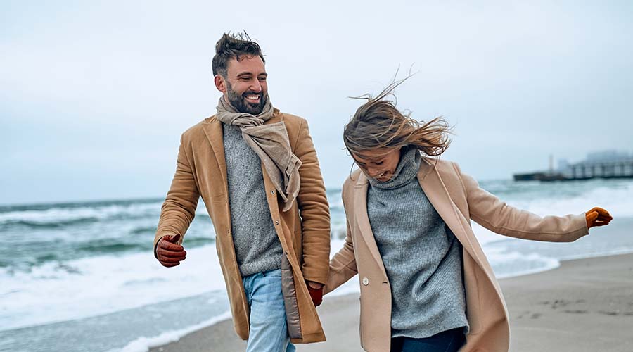 Couple walking on Eastbourne beach